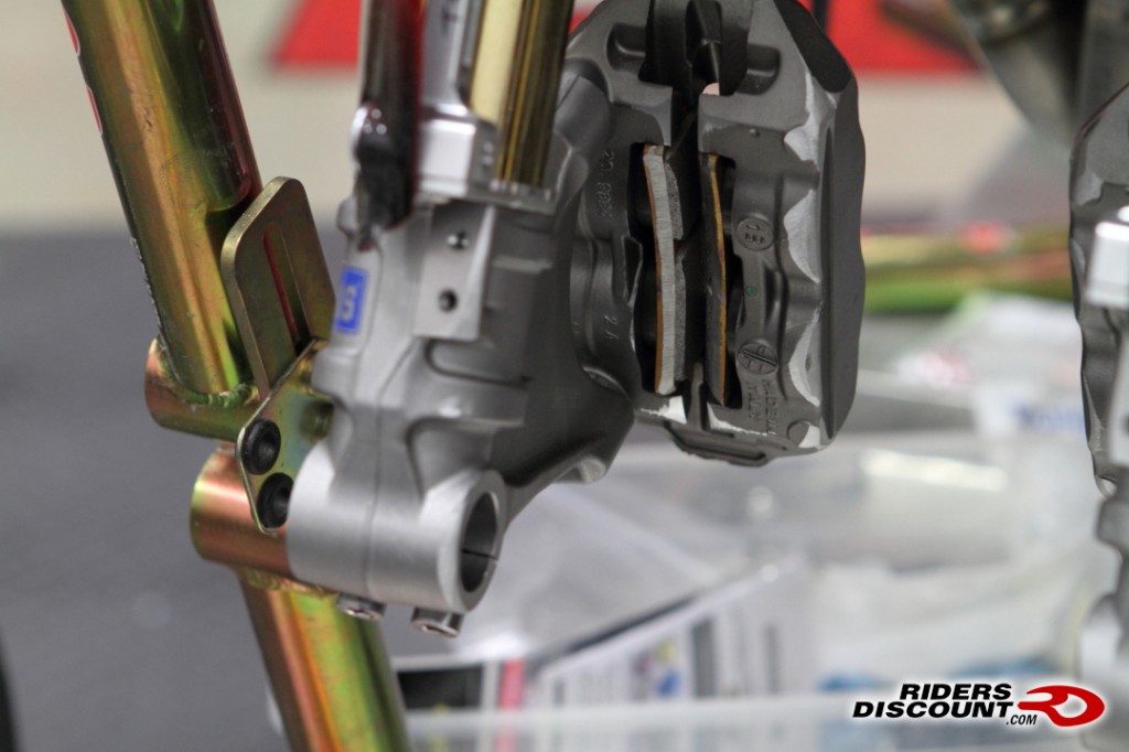 Along with using magnets in the caliper pistons, we also bevel both the front and rear brake pads as well as round the edge of the Brembo calipers and front edge of the fork bottoms.  The allows for a trouble-free installation of the front wheel.